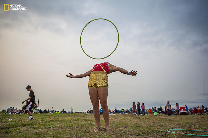 Andrea Grove, a fire performer based in Omaha, Nebraska, practices her hula-hoop routine before her performance at the Lantern Festival on Saturday, August 29, 2015. She travels to events around the Midwest with a group called IncenDance. I met Andrea by chance. She and her group were tucked away behind a stage preparing for their show. After getting to know them a bit, I asked if I could photograph their practice and stayed with them until dark.